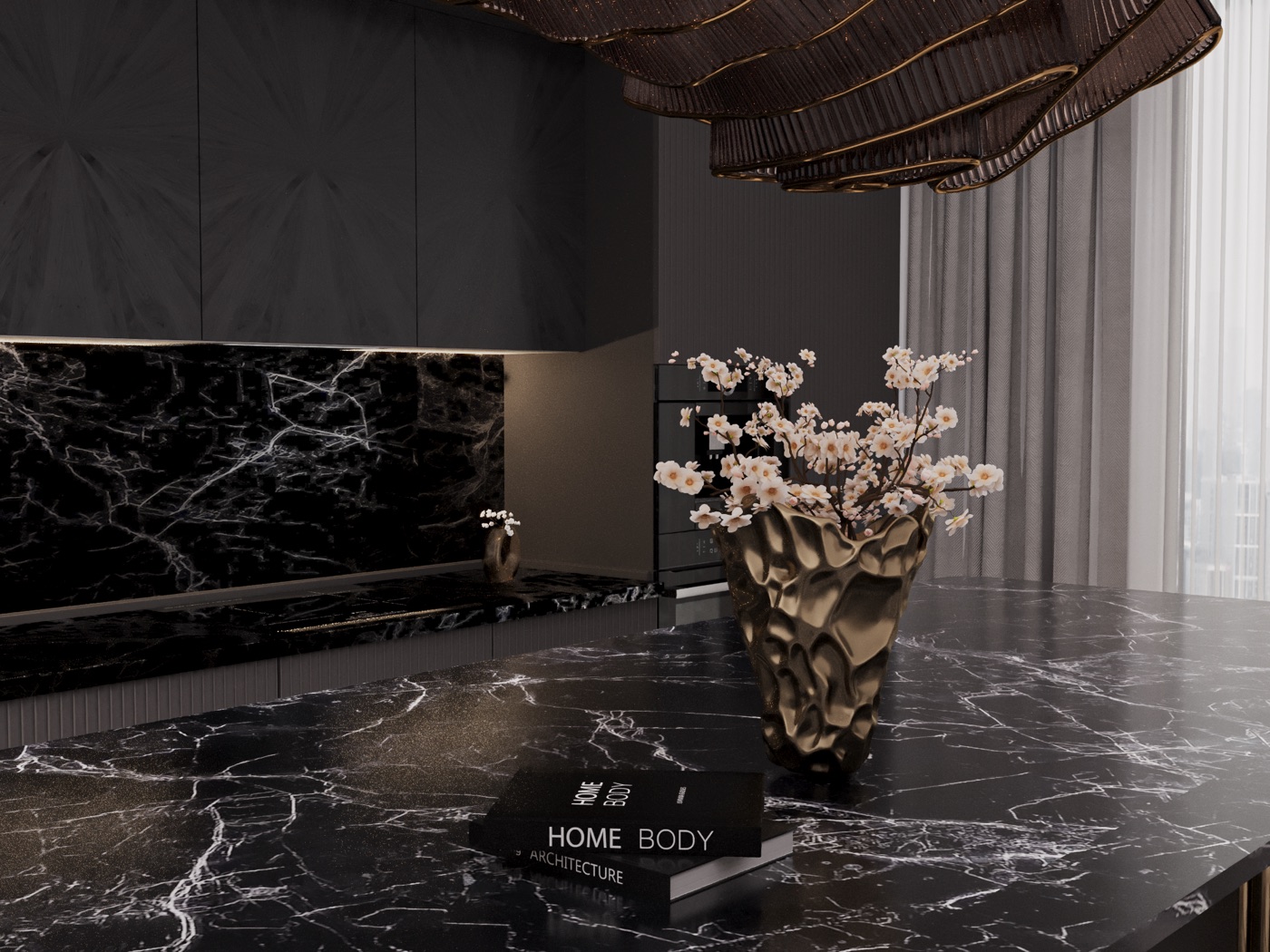 Dark marble kitchen with sculptural lighting and floral decor